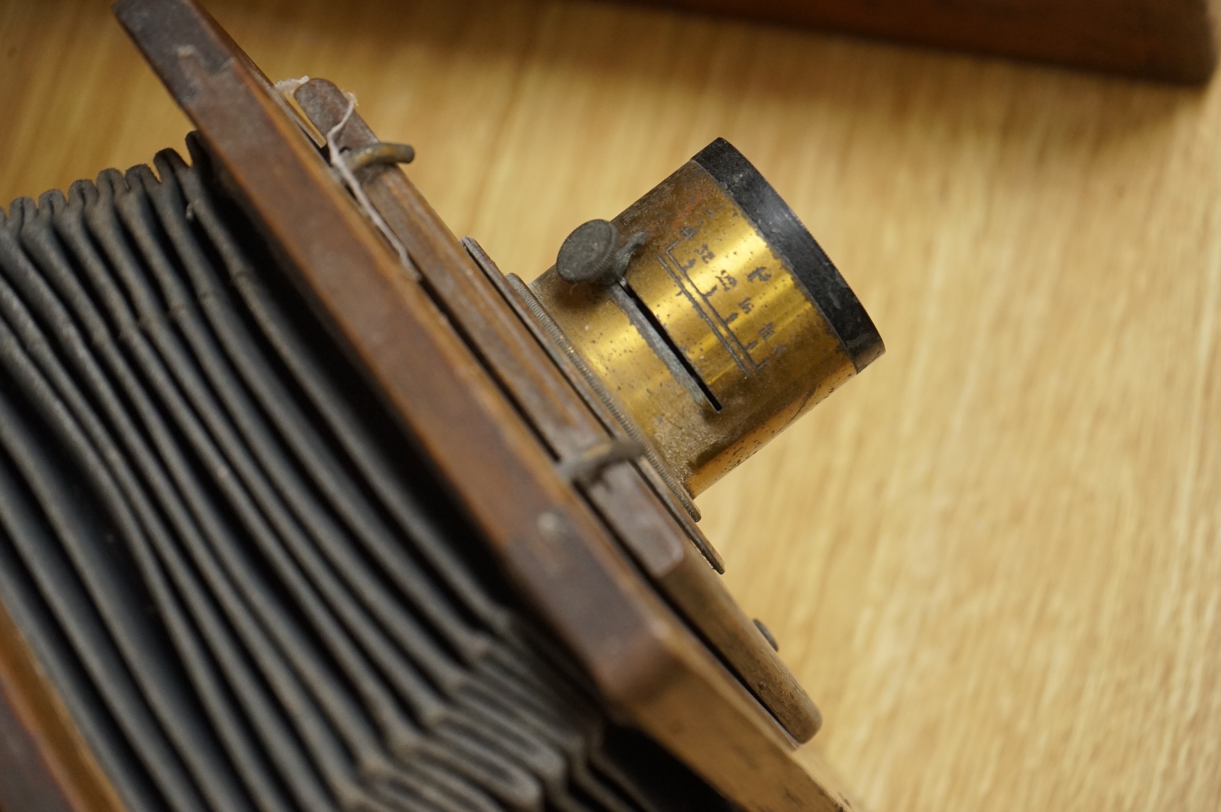 A late 19th century mahogany and tinplate magic lantern style horizontal photograph enlarger, together with some related items.